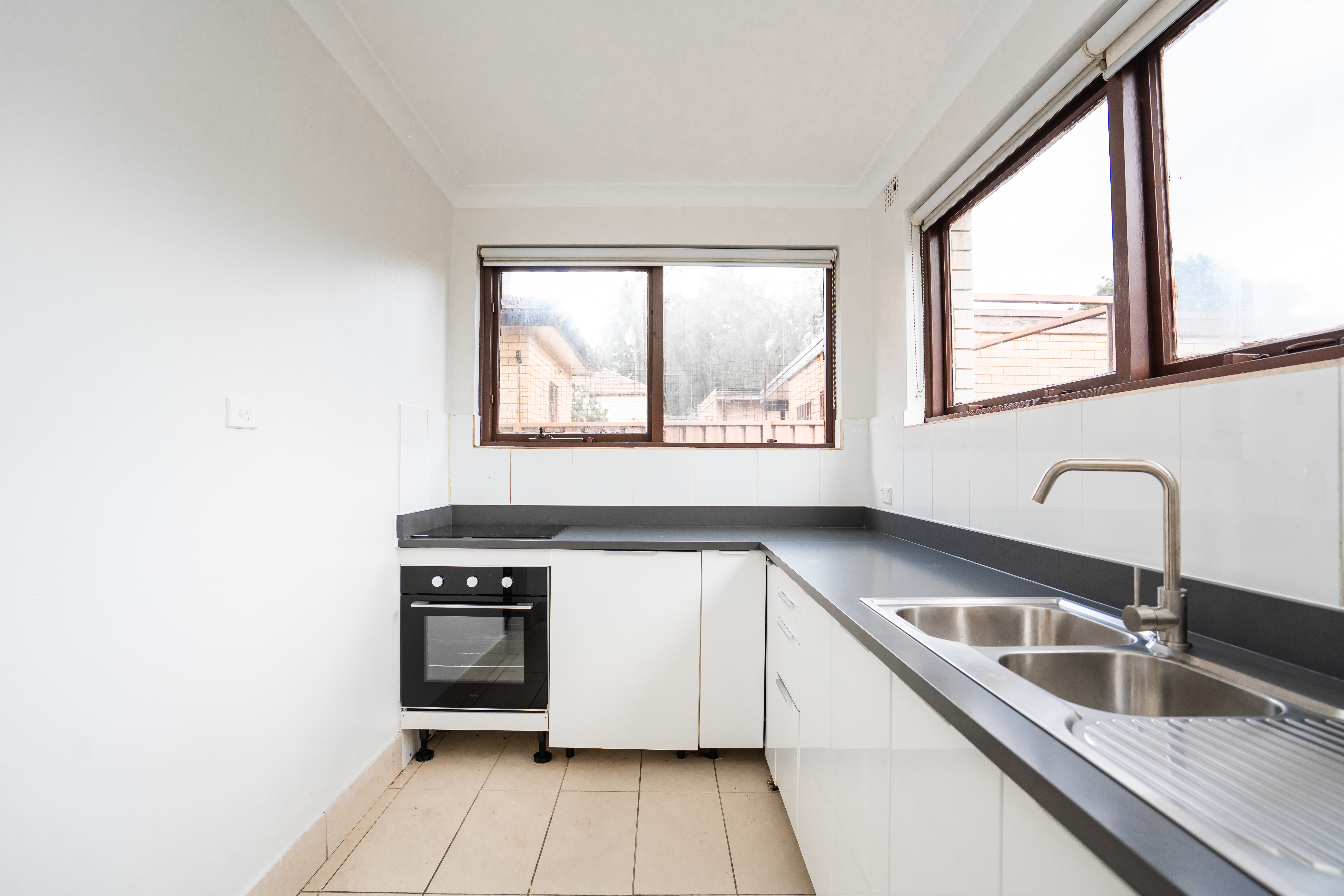 Kitchen tiling — white splashback tiles with beige floor tiles