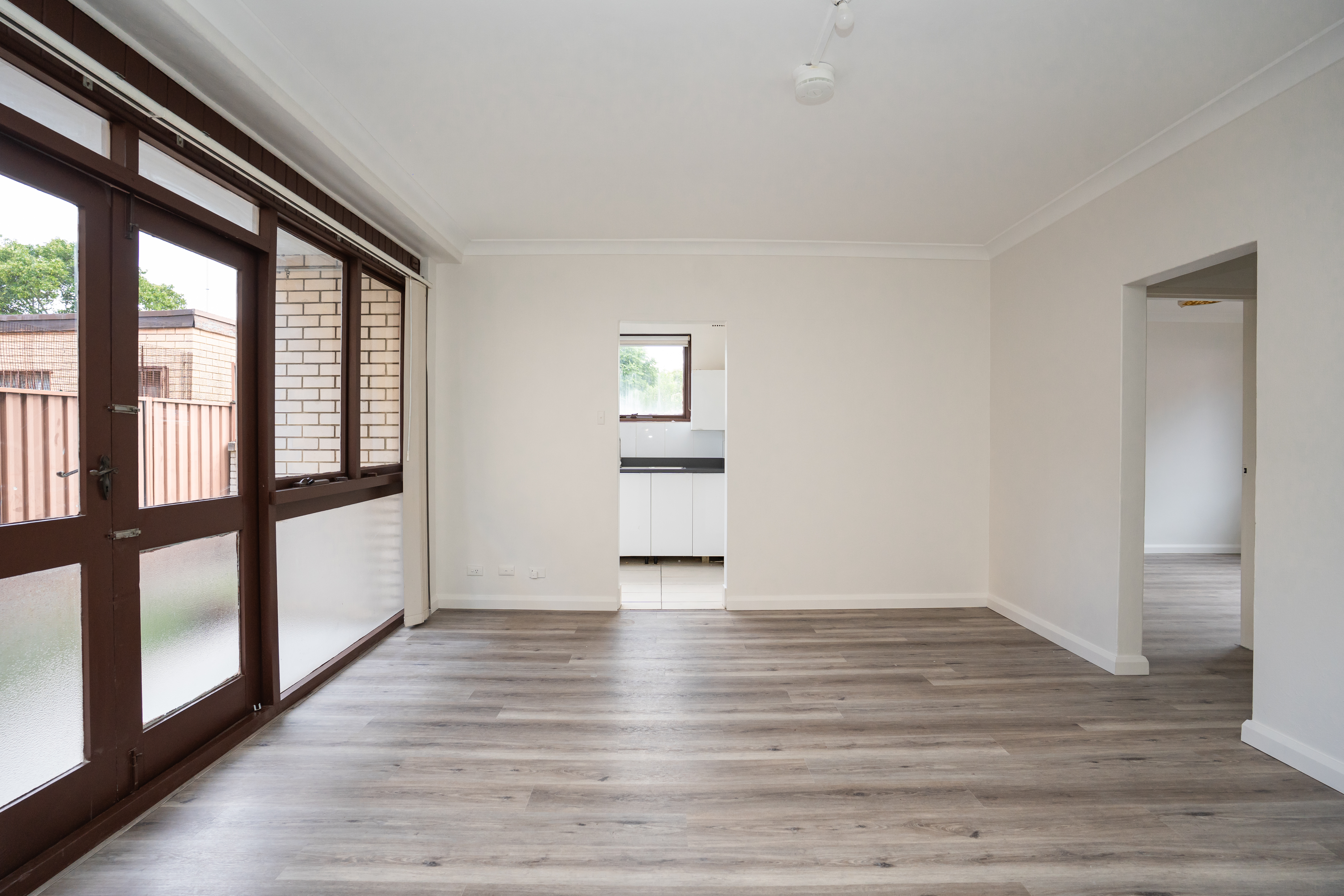Open-plan living — timber flooring with sliding doors to balcony